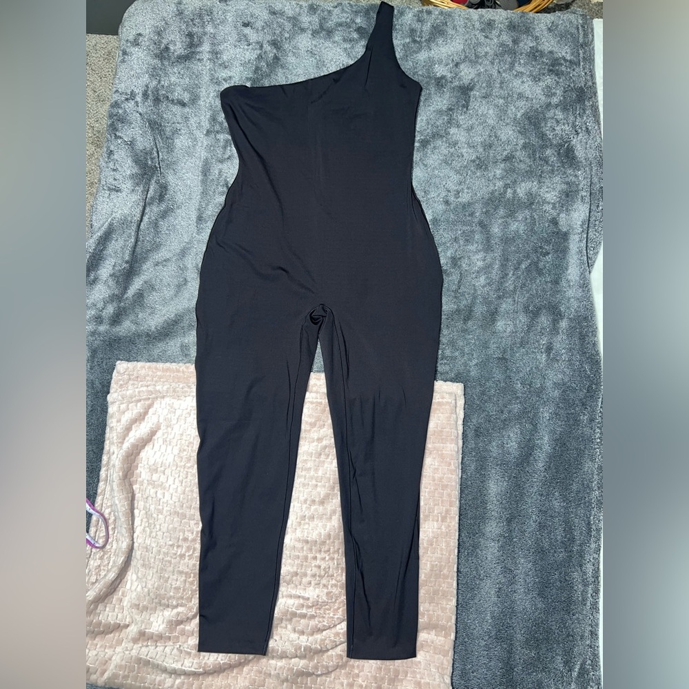 SKIMS Black One Shoulder Jumpsuit for a Sleek Look